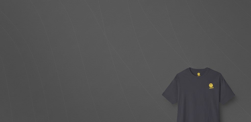 Oversized Tee Dark Grey with yellow logo on front, displayed on gray background