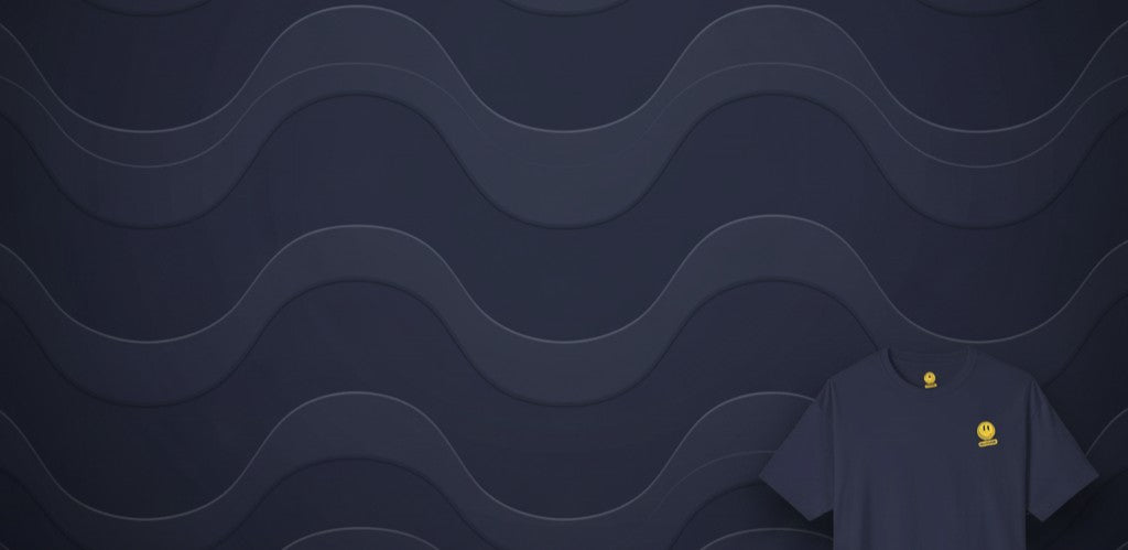 Oversized Tee Navy with a navy blue wavy background, showcasing the stylish tee.